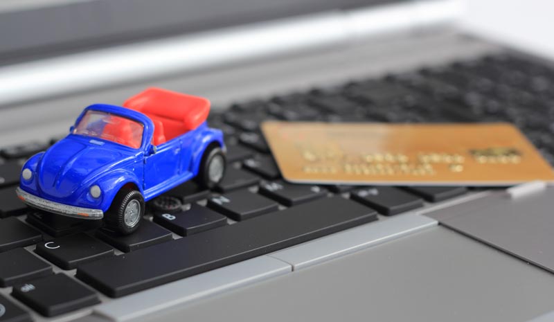 A toy car next to a credit card