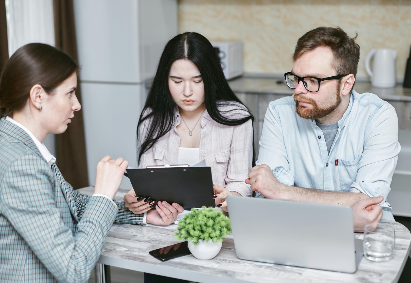 A bankruptcy lawyer showing a document to a couple.