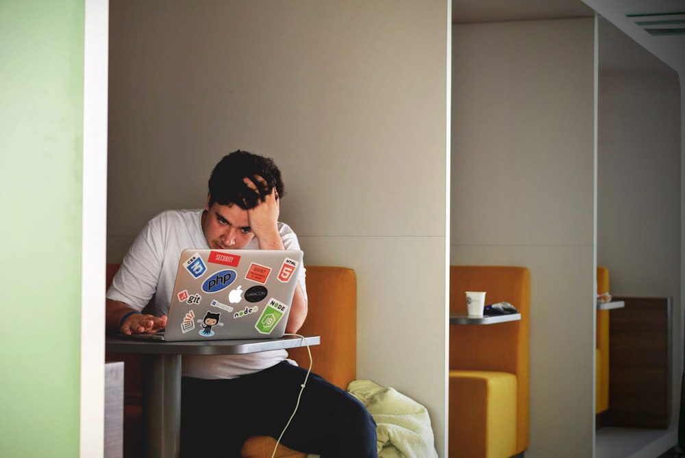 A person sitting at a table with a laptop