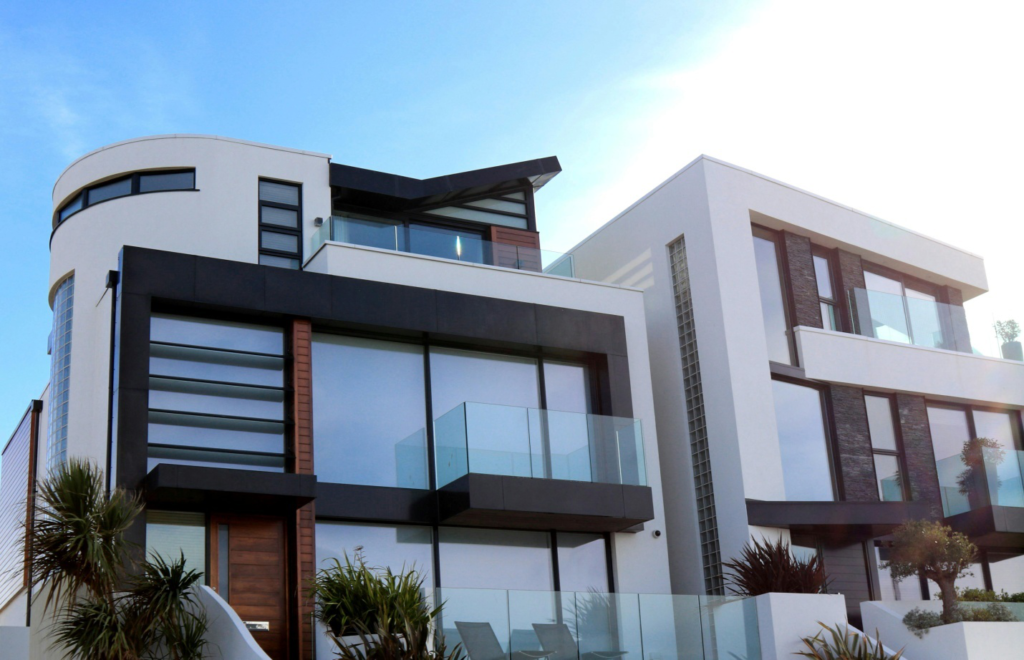 A modern style house with glass balconies and an ocean view.