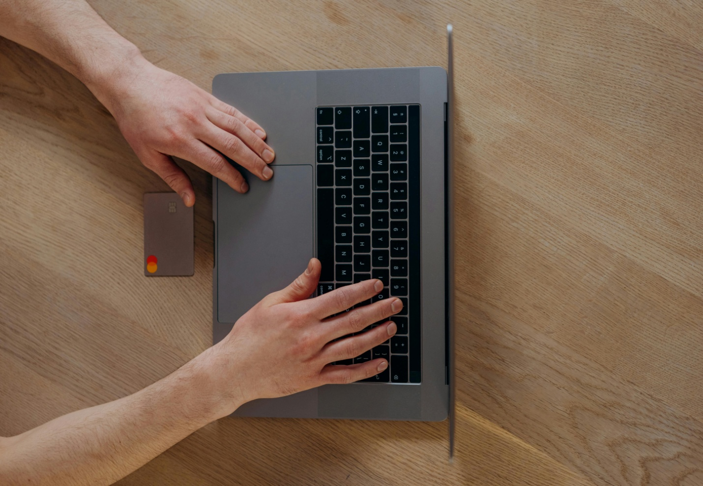 A person using their laptop on the table