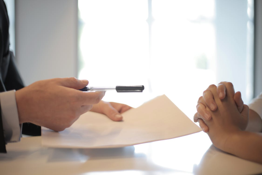 A person is holding a pen and paper