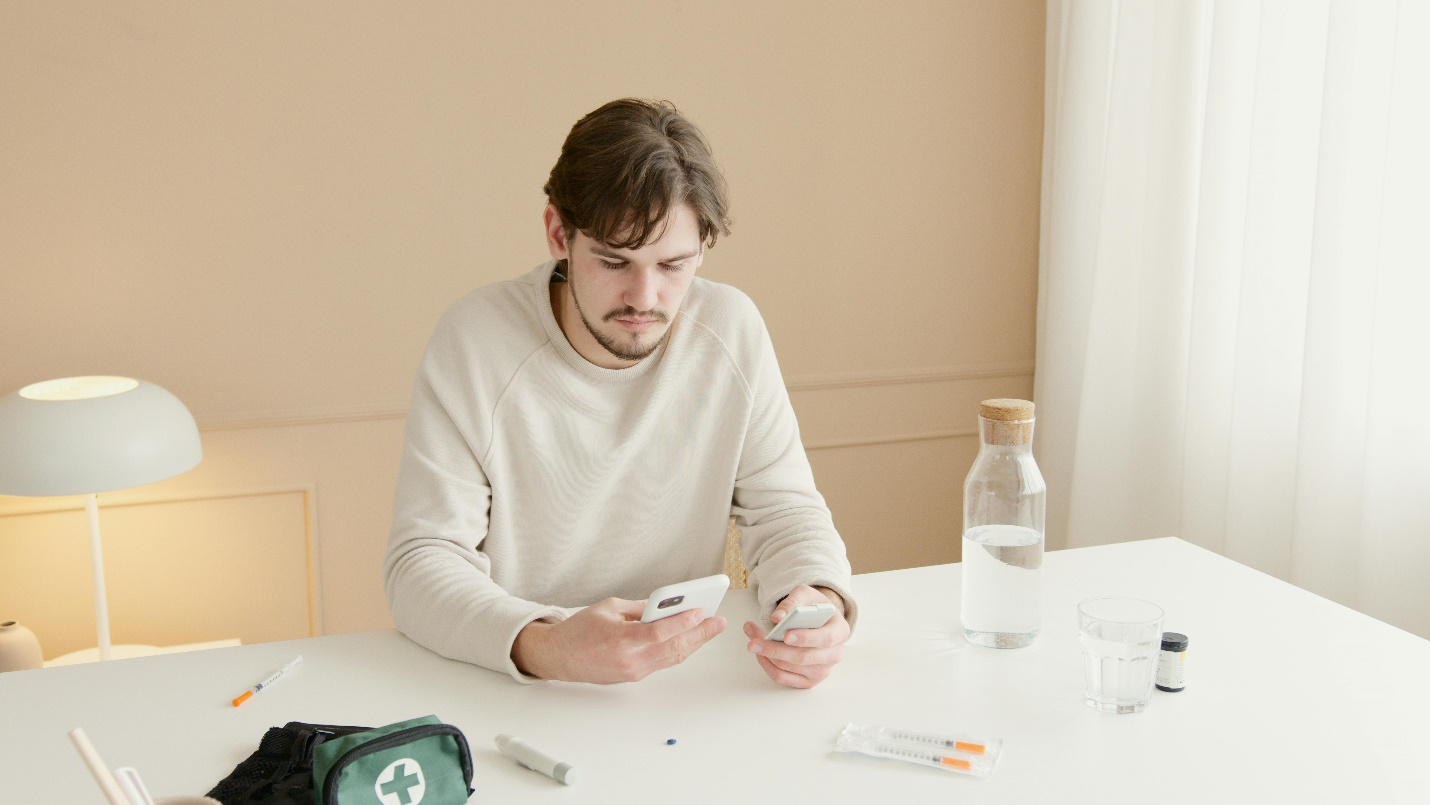 A man sitting at a table with some medications.