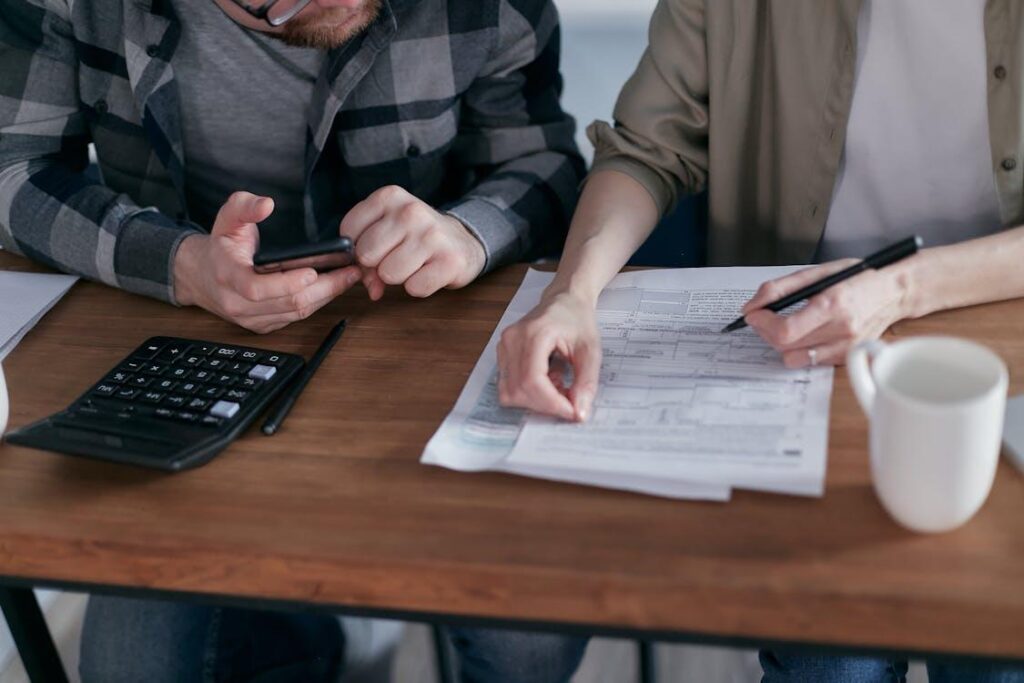 A group of people sitting at a table with papers.