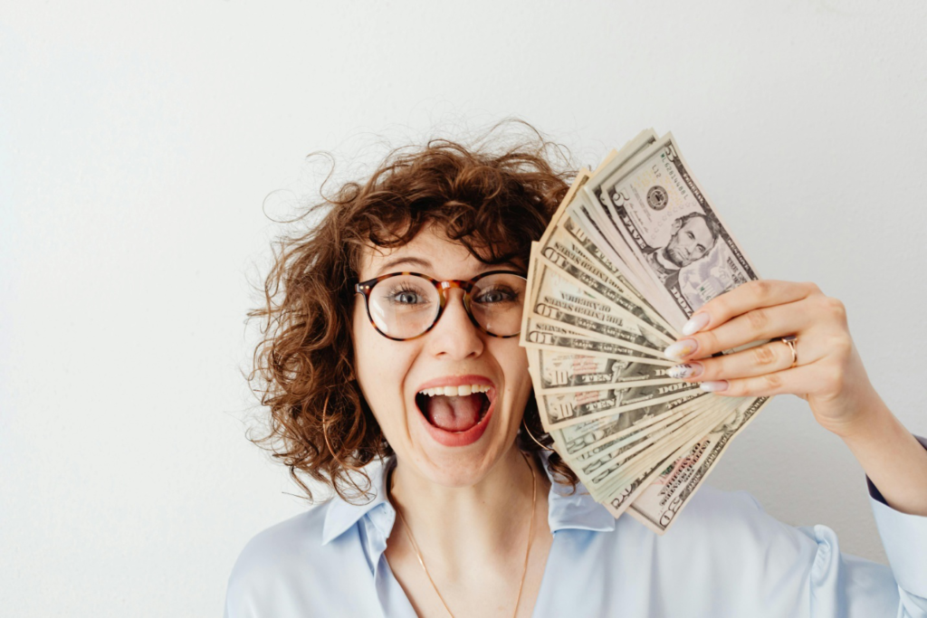 A woman holding dollar bills