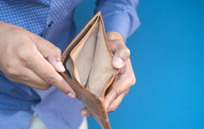 A person opening an empty wallet