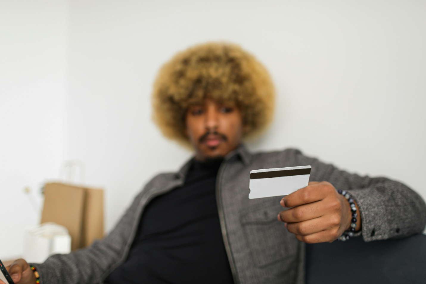 A man holding a credit card