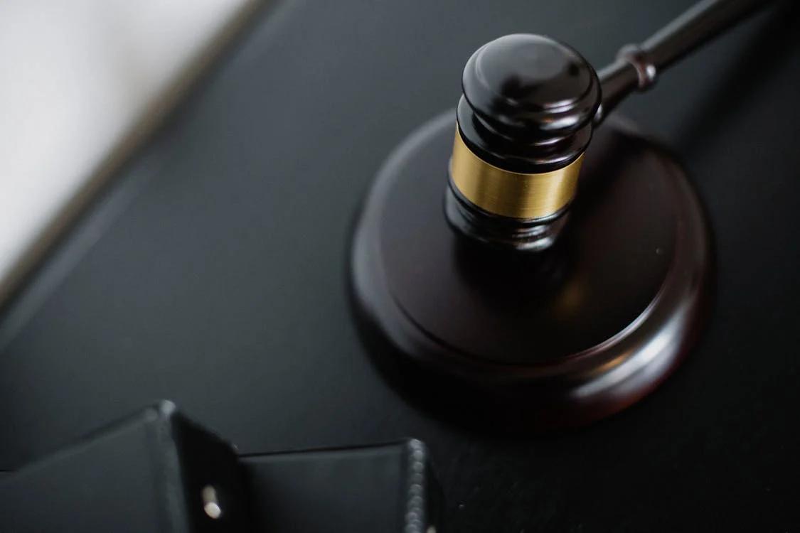 A classic wooden gavel on a polished table symbolising authority and justice