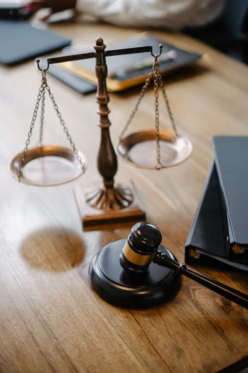 A gavel on a table representing the enforcement of law in a legal setting