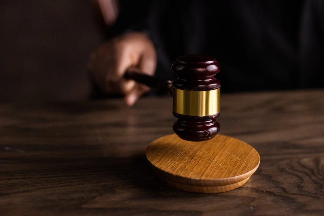 A gavel in a courtroom setting representing legal proceedings and decision-making