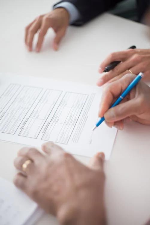 A pen and contract on a desk representing a legal agreement