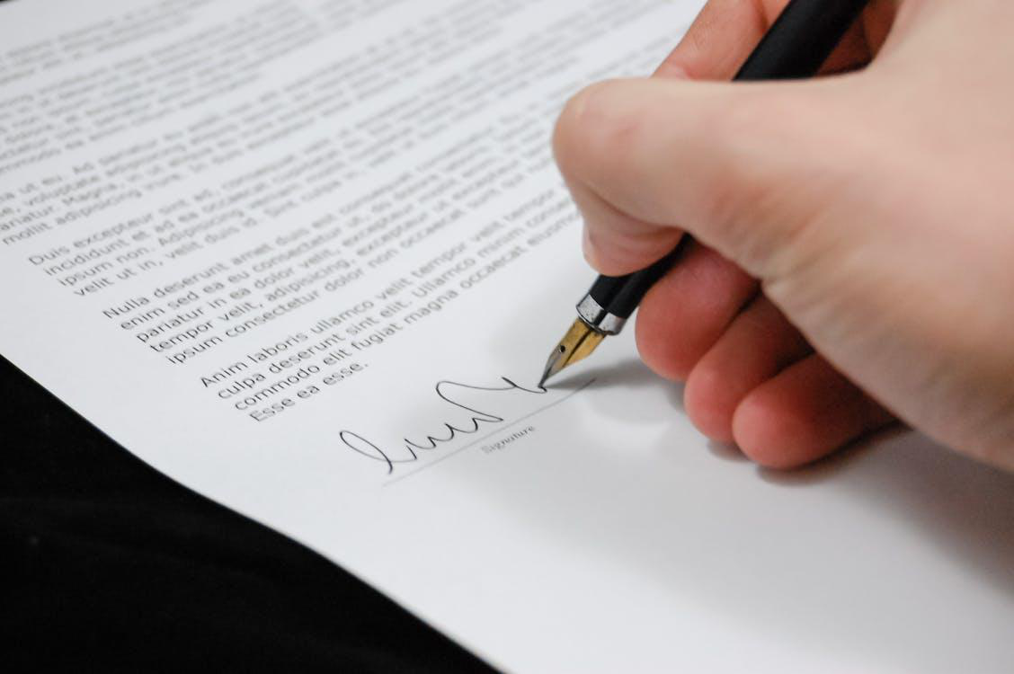 an individual signing a document 