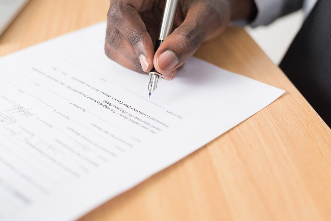 an individual signing a document