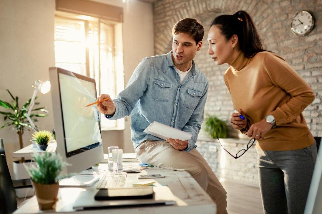 A man and a woman looking at a screen