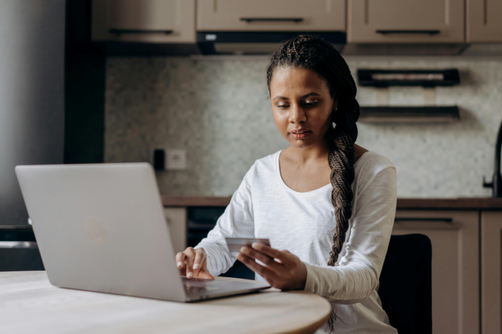 A woman entering credit card details into her laptop