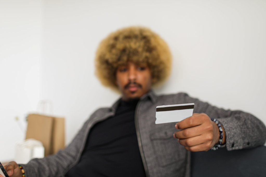 A man looking at a credit card