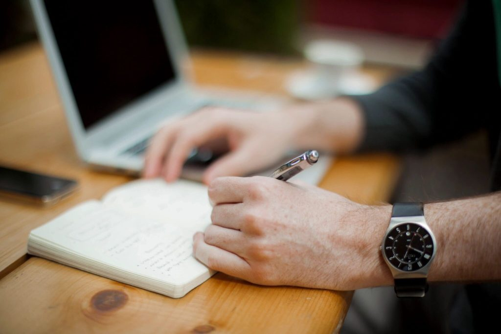 A person writing on a notpad