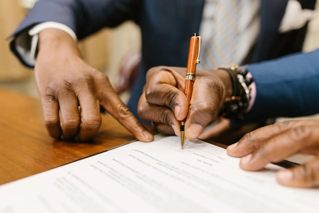 an individual signing a document
