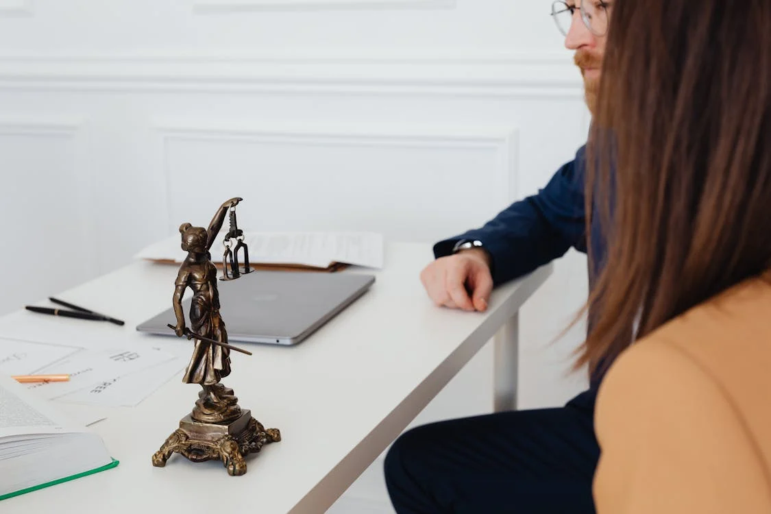 individuals sat at an attorney's table amidst a discussion