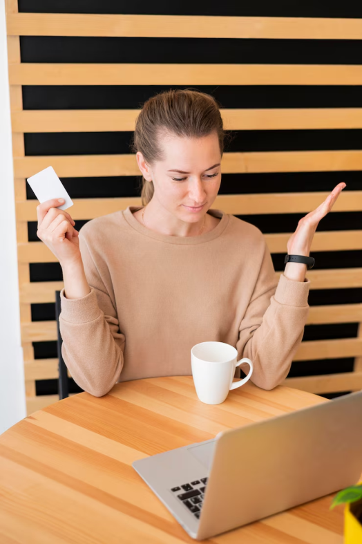 A woman sitting across a laptop