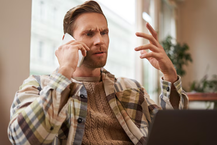 A man speaking on the phone