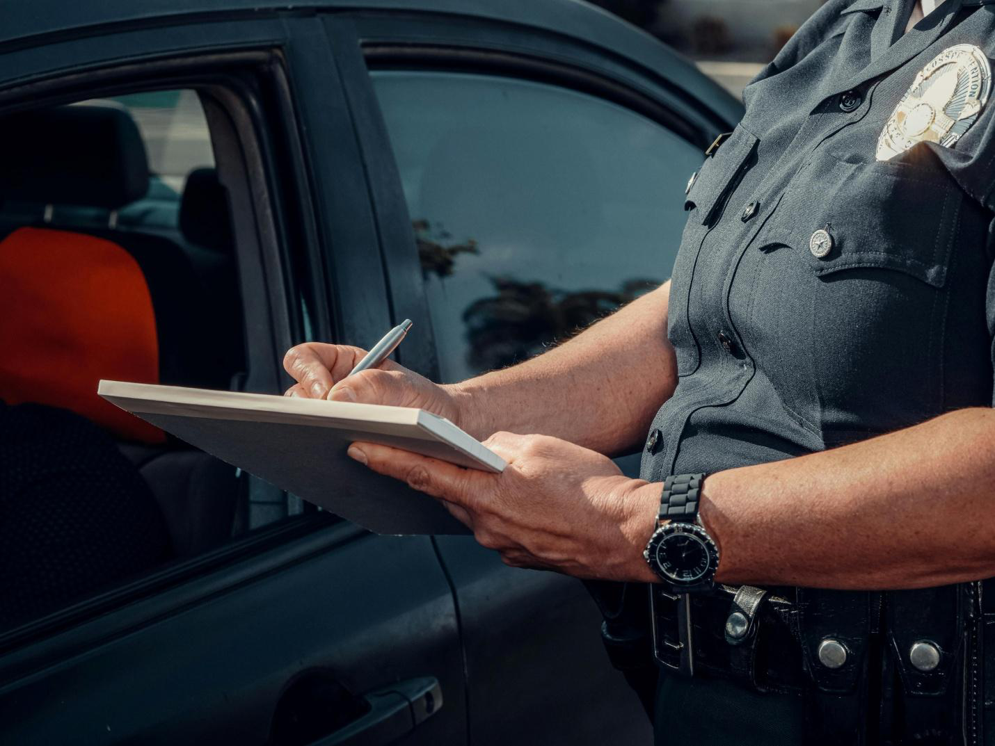 close-up of a notepad in a police officer's hands