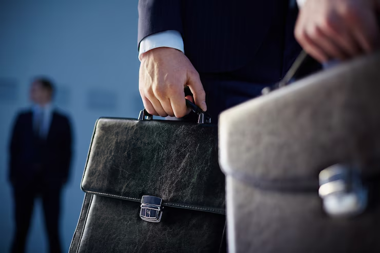 A lawyer standing outside the courthouse holding a briefcase.