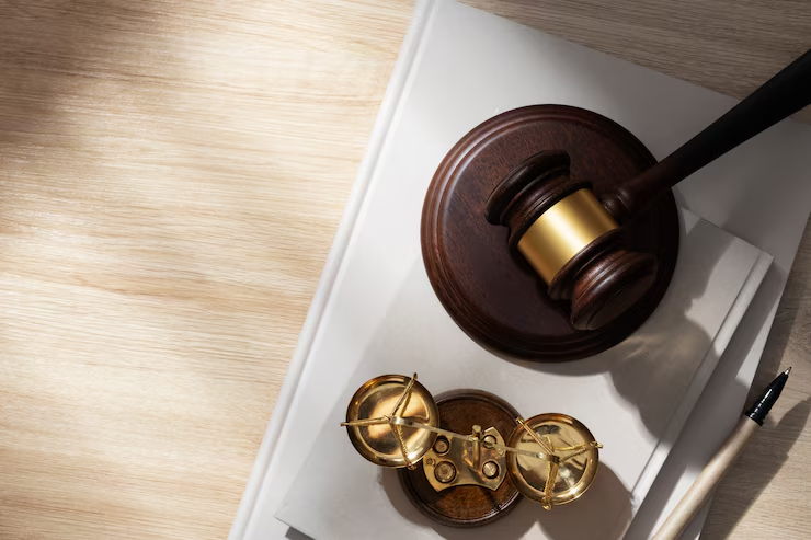 A legal documents, a gavel, and a justice statue representing debt resolution and legal advocacy