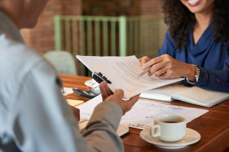 A bankruptcy attorney consulting with a client at a desk.