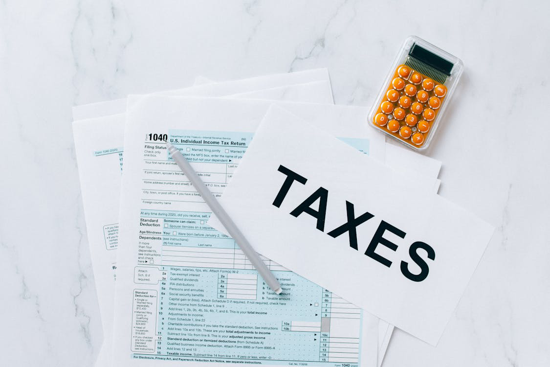 Close-up of a table filled with tax documents and a calculator