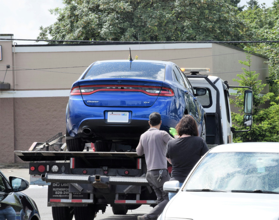 A car being towed away by a tow truck