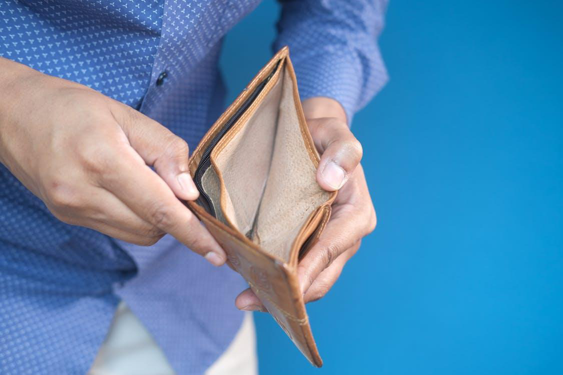 A person looking into an empty wallet