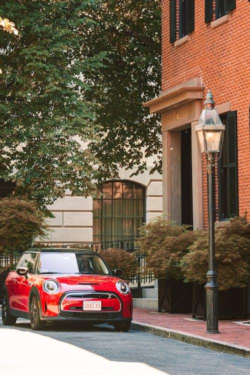 A red car in front of a building