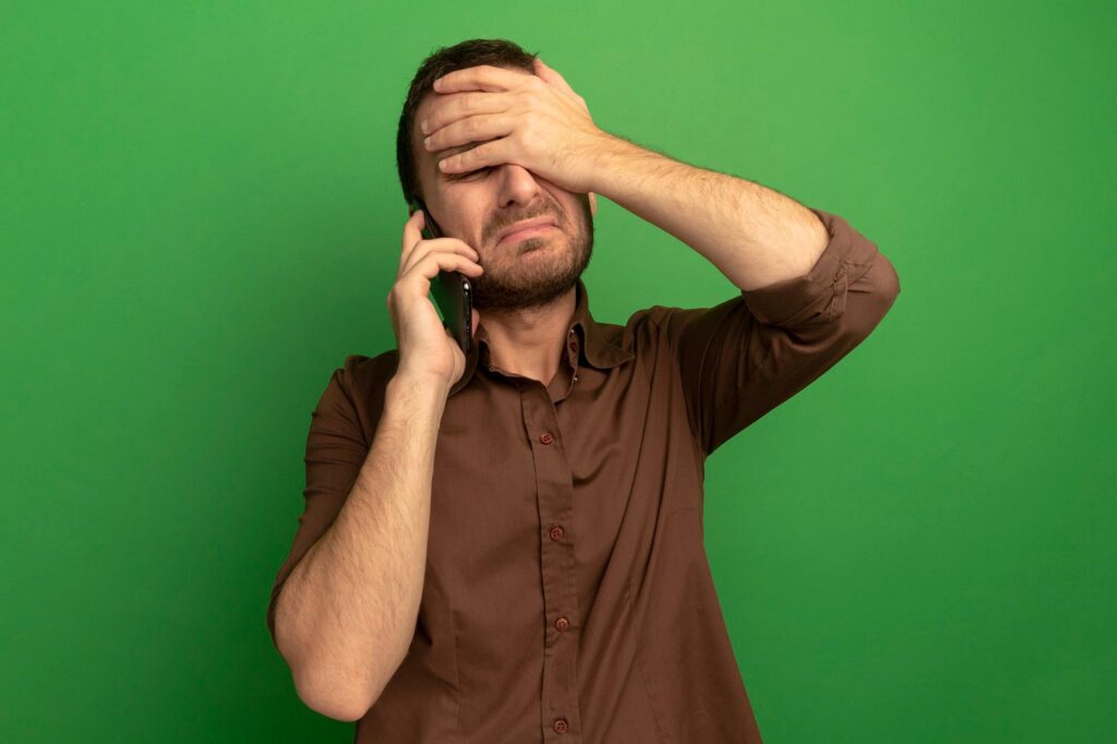 Worried man receiving a threatening collection call in Beeville despite making payments