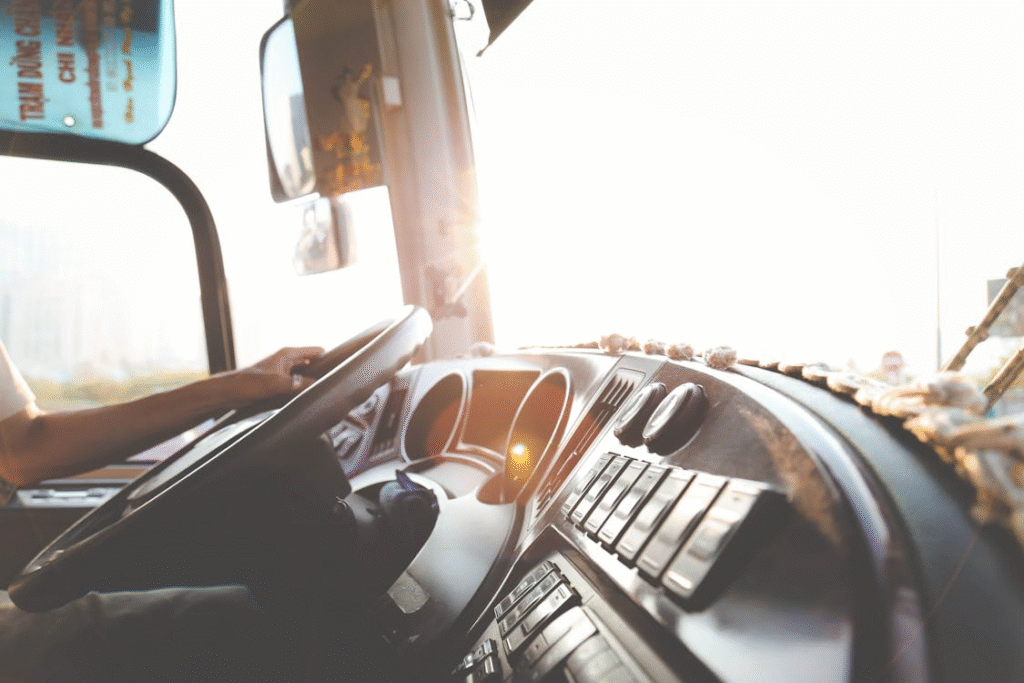 close-up of a person's hands on a bus's steering wheel