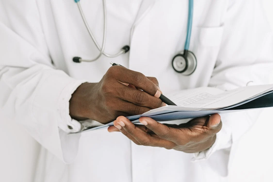 a doctor holding papers in a file