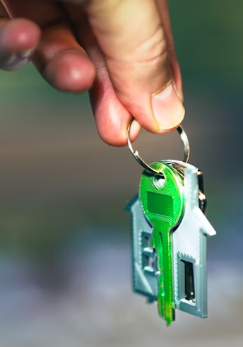 This image shows a hand holding a house key.