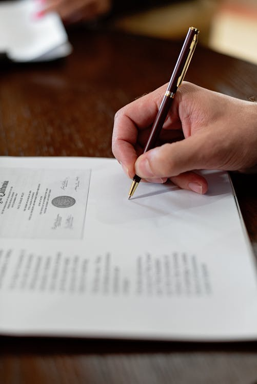 A person signing legal papers. 