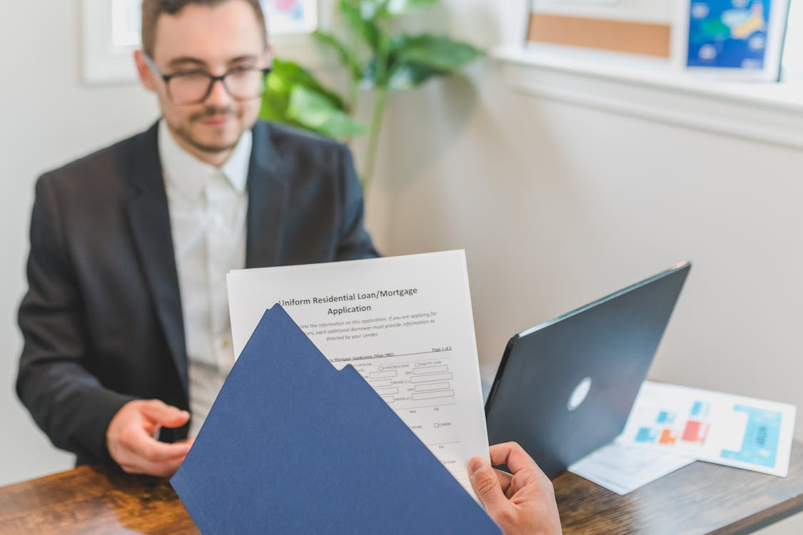 A person signing on files and papers.