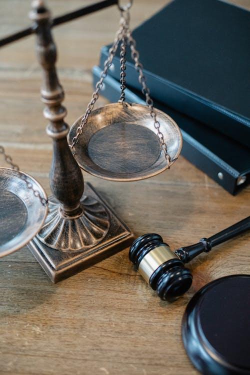 Justice scale and gavel on a table representing legal authority and protection