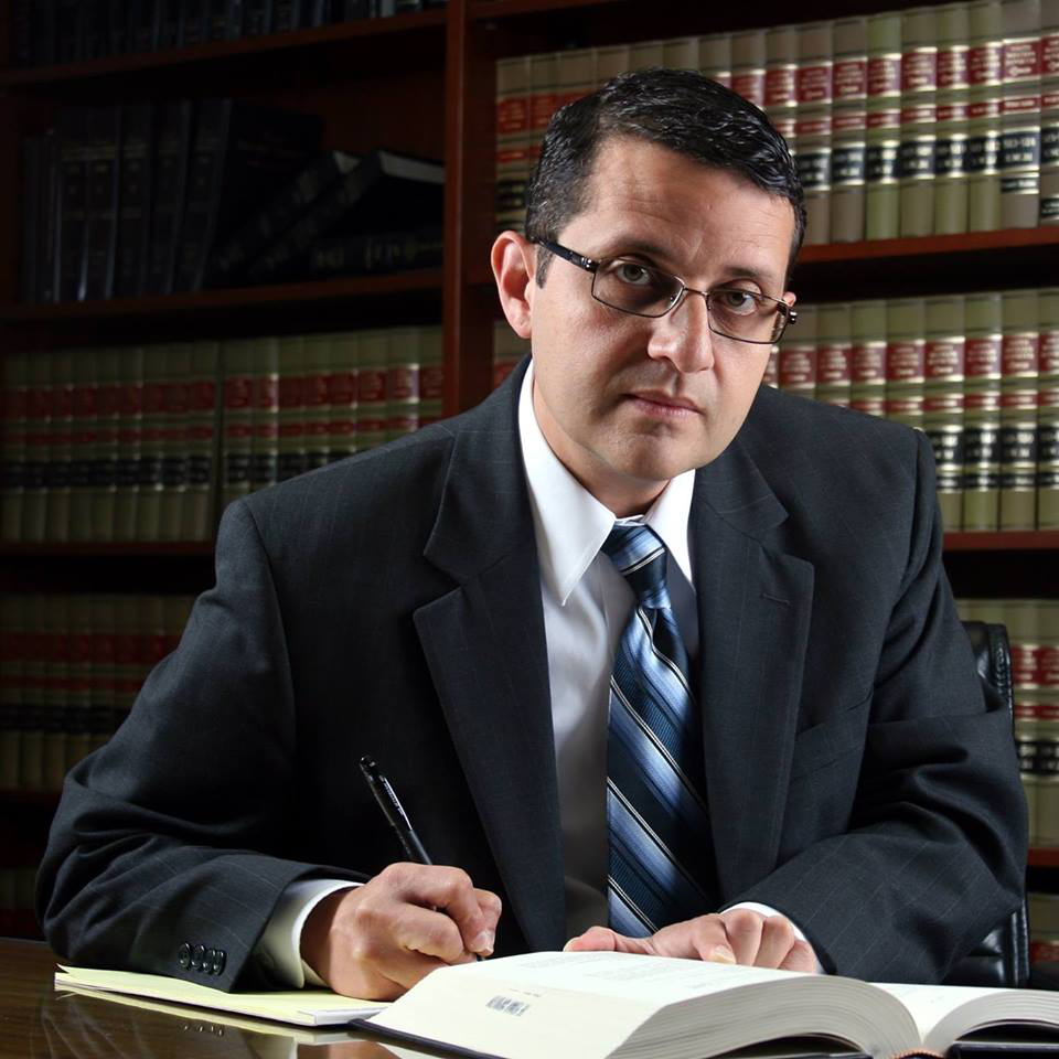 A person signing several papers.