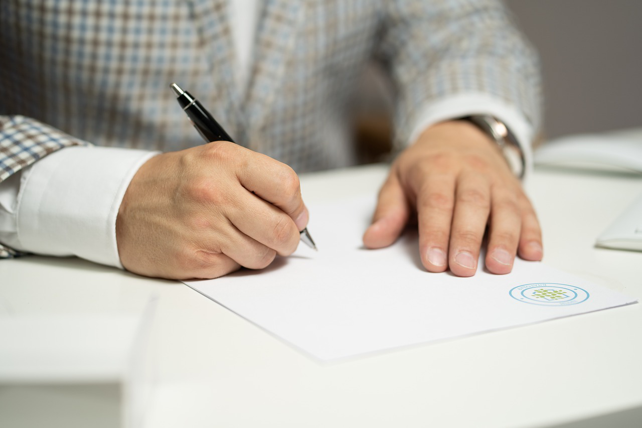 A man signing a document