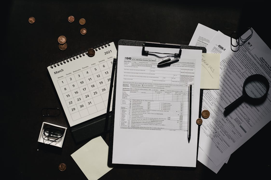 A calendar showing tax due date, surrounded by tax documents