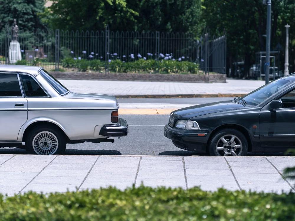 Two vintage cars parked together highlight the importance of protecting your vehicle when facing a repossession lawyer in Victoria.