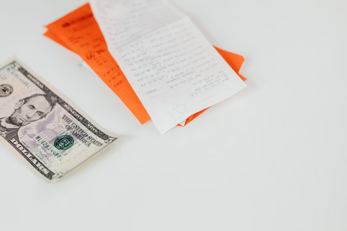  A US dollar bill next to a note 